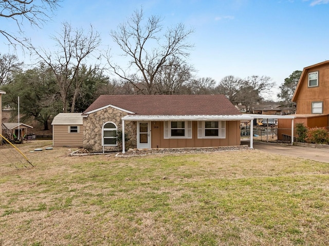 view of front of home with a carport, a front yard, stone siding, and concrete driveway