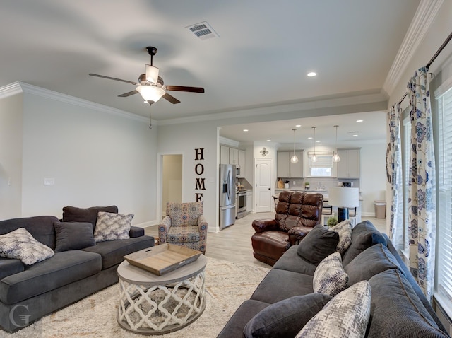 living area featuring crown molding, light wood finished floors, recessed lighting, visible vents, and baseboards