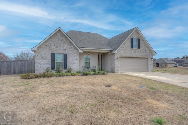 traditional-style home with brick siding, fence, concrete driveway, roof with shingles, and a front lawn