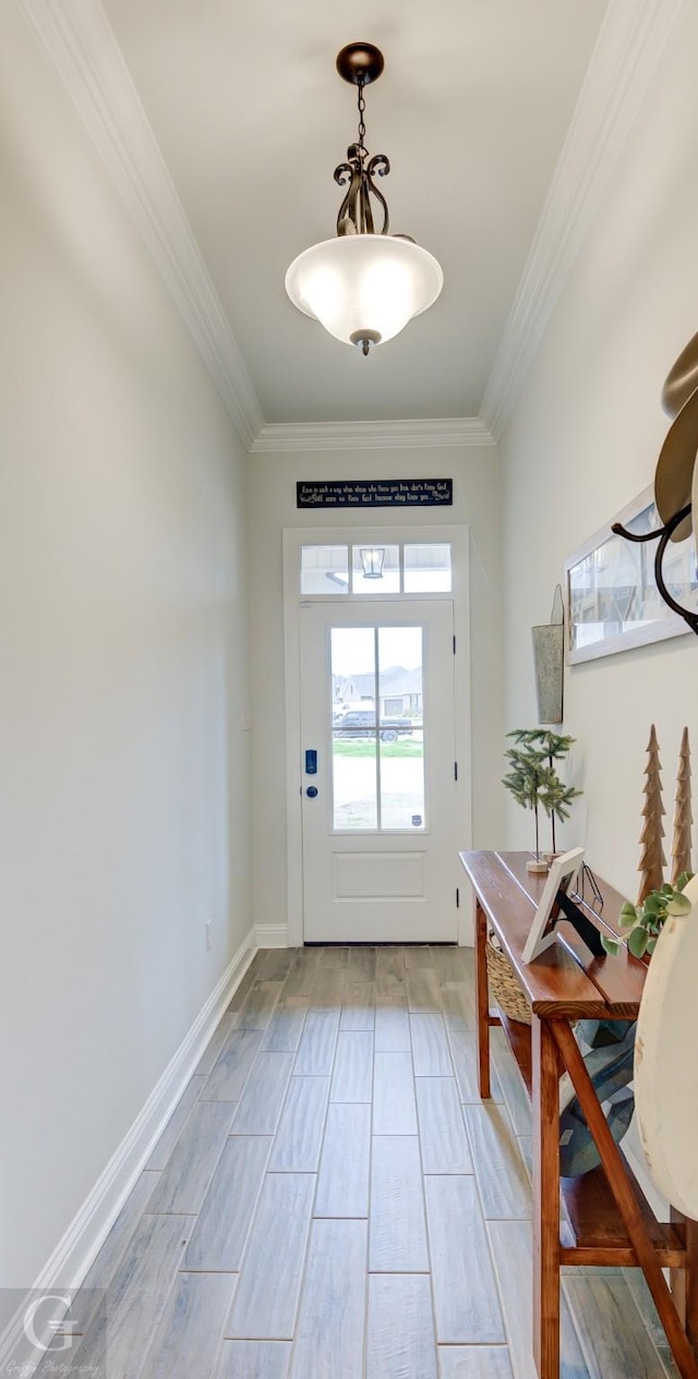 doorway with baseboards and crown molding