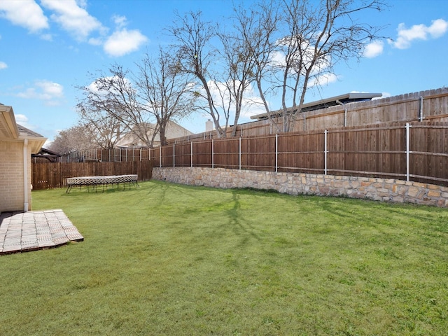 view of yard with a fenced backyard