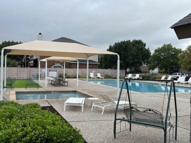 community pool featuring a patio and fence