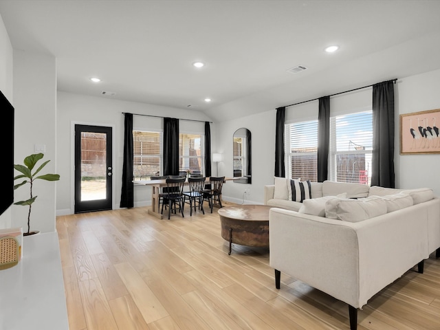 living room featuring light wood-style floors, visible vents, and recessed lighting