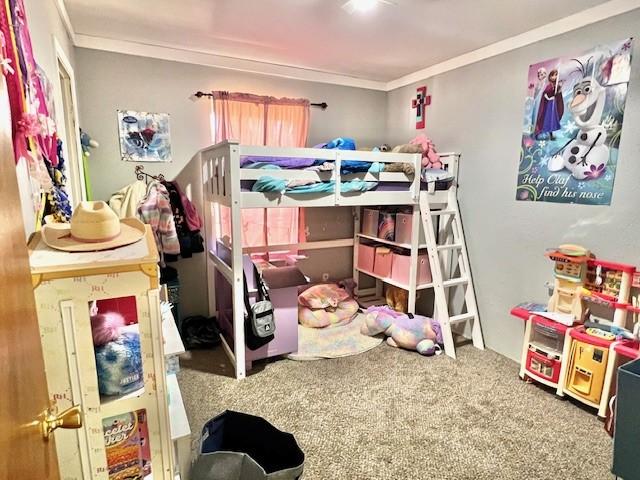 bedroom featuring carpet floors and crown molding