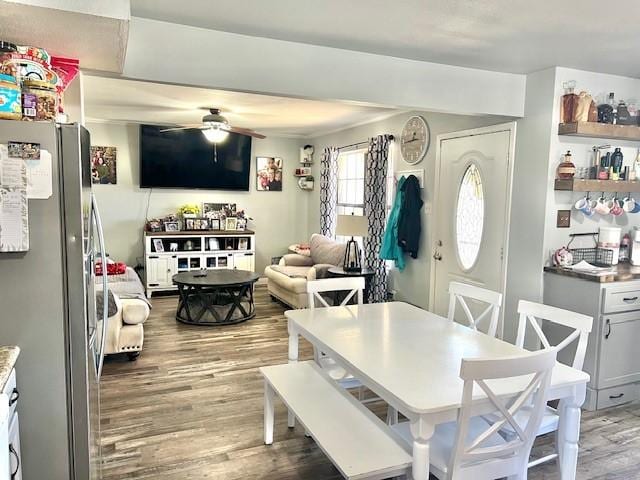 dining space featuring light wood-type flooring and ceiling fan