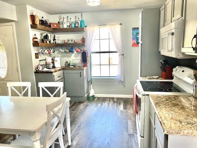 kitchen with white appliances, baseboards, gray cabinets, and dark wood-style flooring