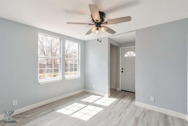 spare room with ceiling fan, wood finished floors, and baseboards