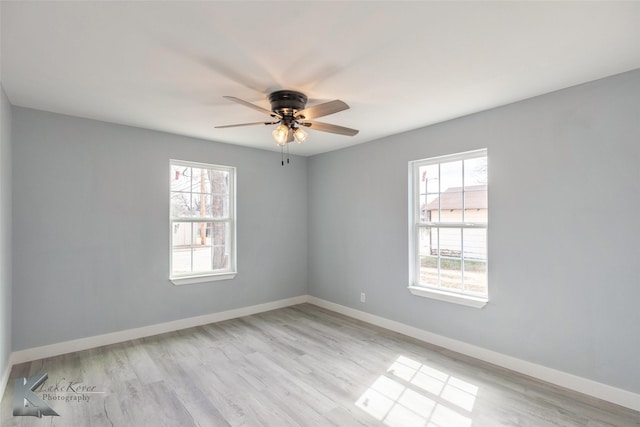 unfurnished room with light wood finished floors, ceiling fan, baseboards, and a wealth of natural light