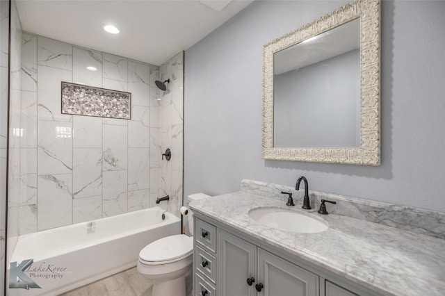 bathroom featuring shower / bathing tub combination, vanity, toilet, and wood finished floors