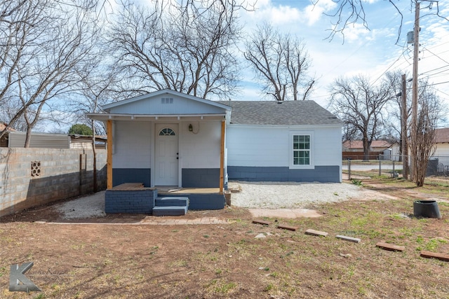 view of front of property with fence and roof with shingles