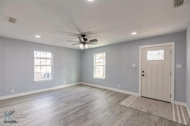 entrance foyer with baseboards, visible vents, and light wood finished floors