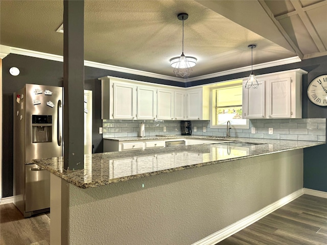 kitchen featuring a peninsula, decorative backsplash, white cabinetry, and stainless steel fridge with ice dispenser