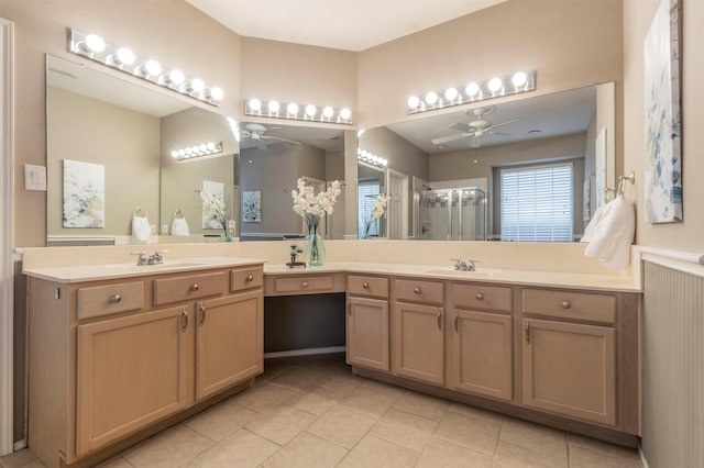 bathroom with tile patterned floors, vanity, a stall shower, and a ceiling fan