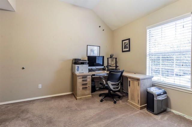 home office featuring light colored carpet, baseboards, and lofted ceiling