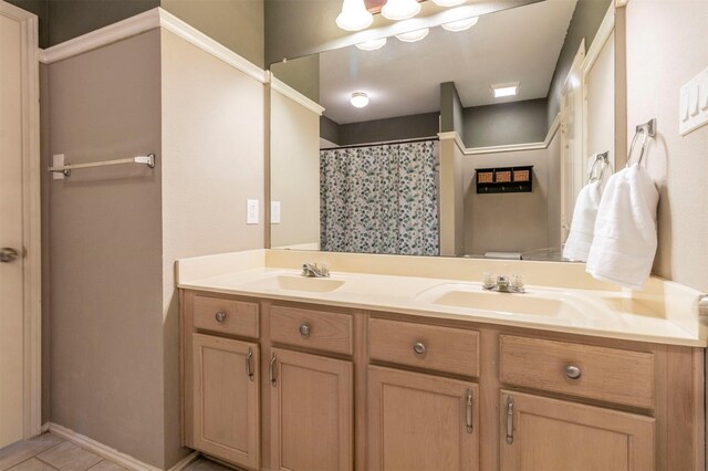 bathroom with double vanity, toilet, tile patterned floors, and a sink