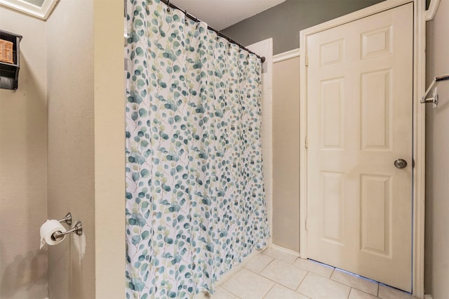 bathroom with tile patterned flooring and a shower with shower curtain