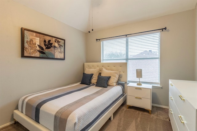 bedroom with baseboards, lofted ceiling, and carpet