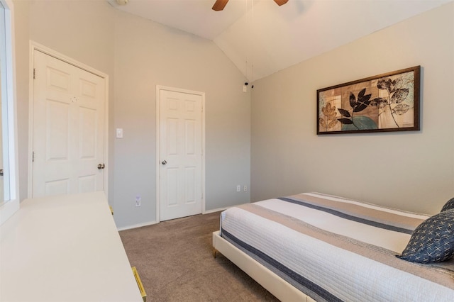 carpeted bedroom featuring vaulted ceiling, a ceiling fan, and baseboards