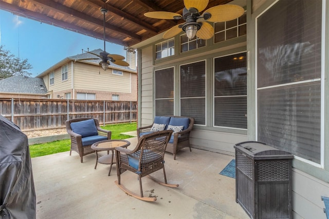 view of patio with an outdoor living space, a ceiling fan, and fence