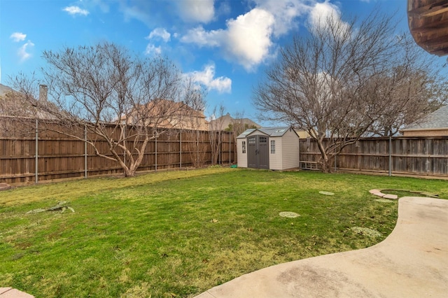 view of yard featuring a storage shed, an outbuilding, and a fenced backyard