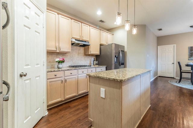 kitchen featuring visible vents, dark wood finished floors, appliances with stainless steel finishes, under cabinet range hood, and tasteful backsplash