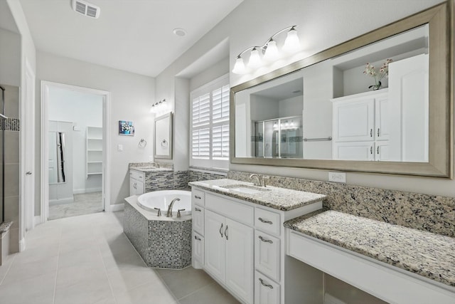 bathroom with tile patterned floors, visible vents, a stall shower, a sink, and a bath