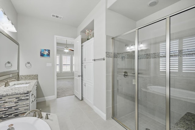 bathroom featuring tile patterned flooring, vanity, visible vents, a shower stall, and a bath