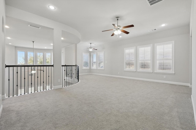 unfurnished room with carpet, visible vents, and recessed lighting