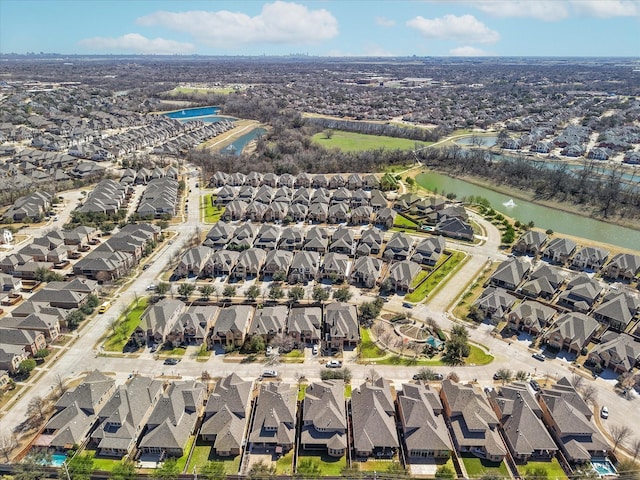 drone / aerial view with a water view and a residential view