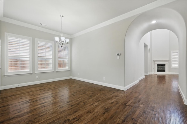 unfurnished dining area featuring dark wood-style floors, a wealth of natural light, visible vents, and baseboards