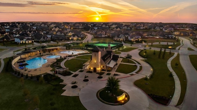 aerial view at dusk featuring a residential view