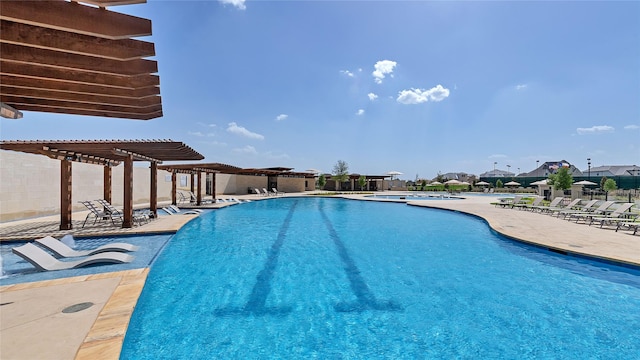 pool with a patio area and a pergola