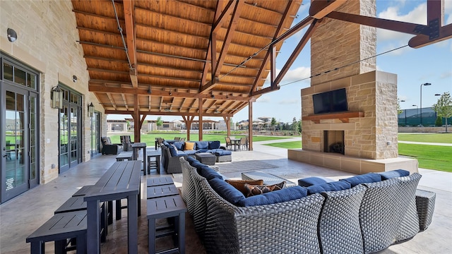 view of patio / terrace with an outdoor living space with a fireplace