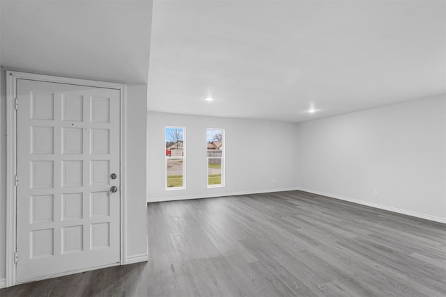 entryway with baseboards and wood finished floors