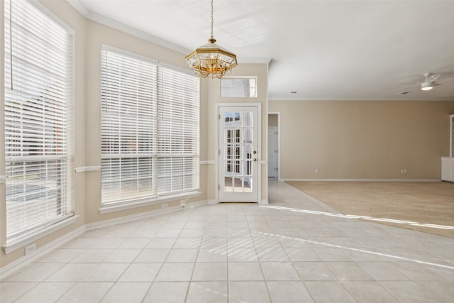 entrance foyer featuring ceiling fan with notable chandelier, ornamental molding, tile patterned flooring, and baseboards