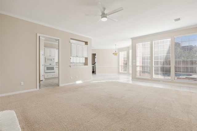 unfurnished room with light carpet, ceiling fan, plenty of natural light, and visible vents