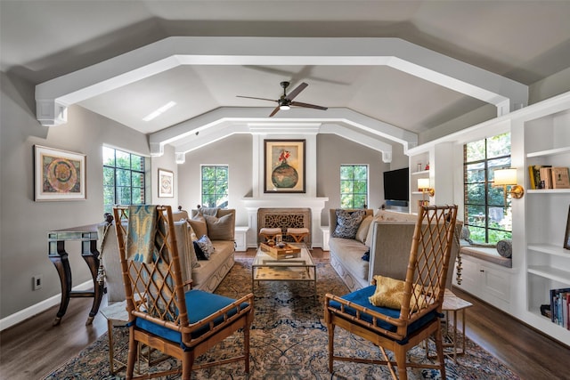 sitting room with a wealth of natural light, vaulted ceiling, and wood finished floors