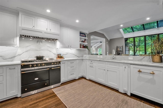 kitchen featuring open shelves, under cabinet range hood, double oven range, and white cabinets