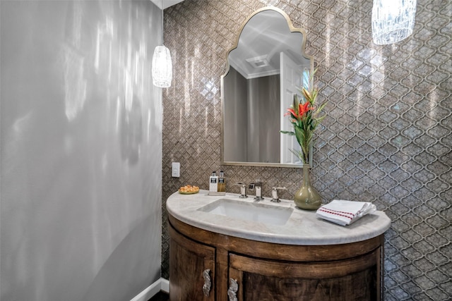 bathroom featuring backsplash, crown molding, and vanity