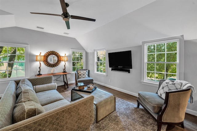 living area featuring lofted ceiling, plenty of natural light, and dark wood finished floors