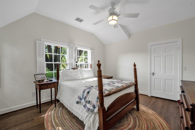 bedroom featuring baseboards, visible vents, a ceiling fan, dark wood-style flooring, and vaulted ceiling