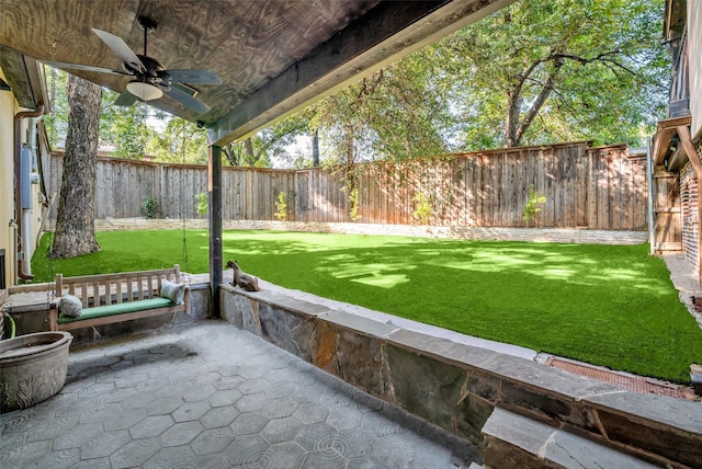 view of yard with ceiling fan, a patio, and a fenced backyard