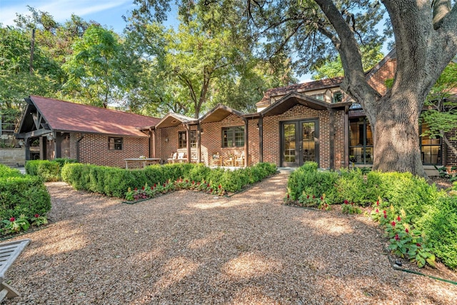 view of front of home featuring french doors and brick siding