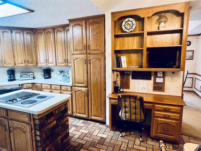 kitchen featuring white electric stovetop, brown cabinets, light countertops, a textured ceiling, and open shelves