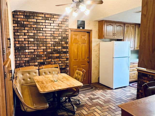 dining space featuring brick floor and a ceiling fan