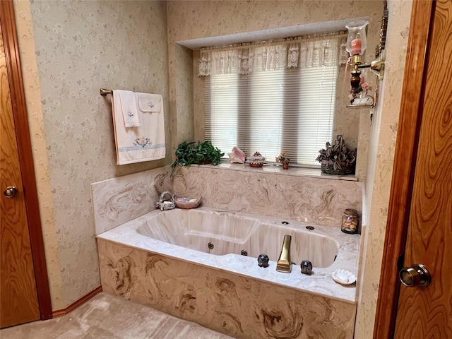 full bath featuring baseboards and a bath