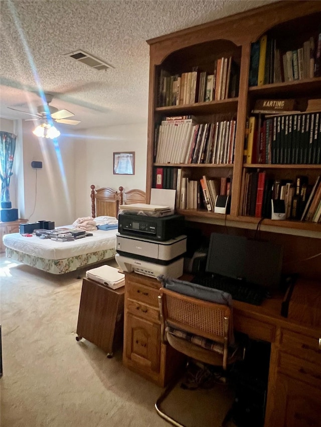 interior space with light carpet, ceiling fan, a textured ceiling, and visible vents