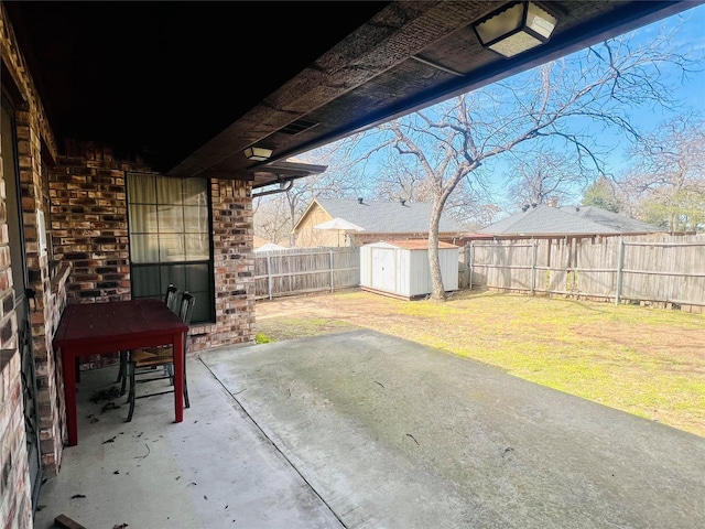 view of patio with an outbuilding, a storage shed, and a fenced backyard