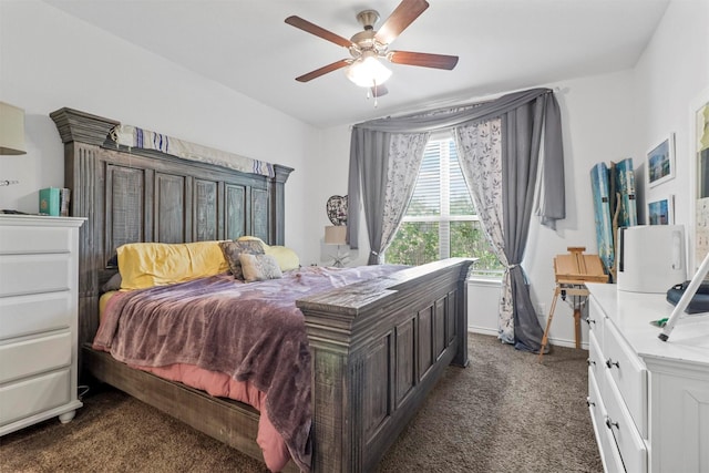 bedroom with lofted ceiling, dark colored carpet, a ceiling fan, and baseboards