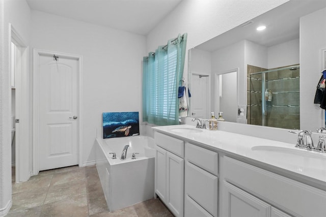 bathroom featuring a stall shower, a garden tub, a sink, and double vanity